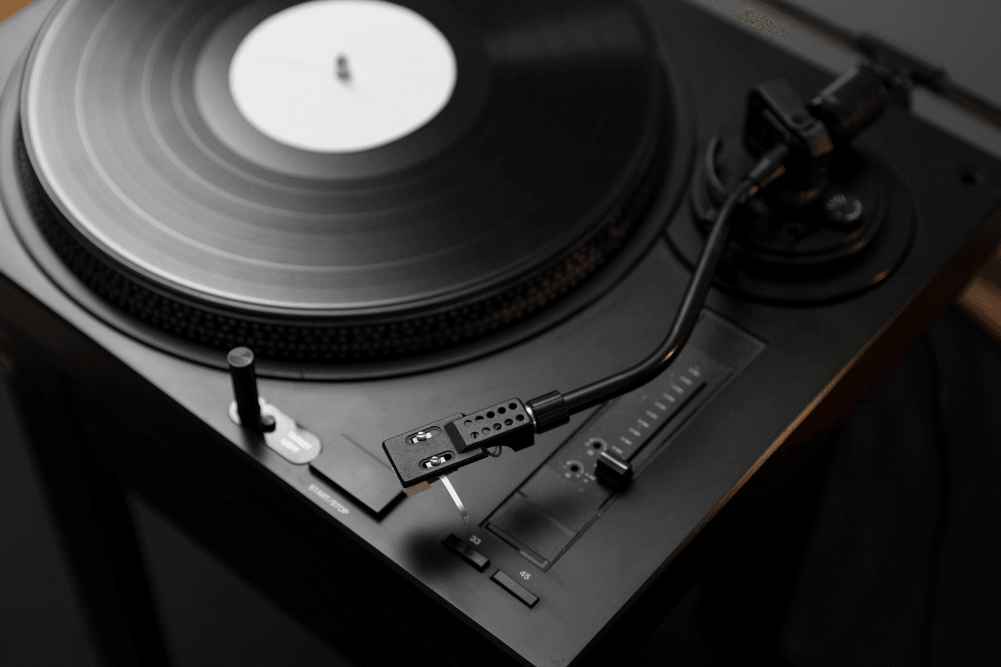 A modern turntable playing a record